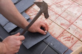roofer cut a slate on a stack